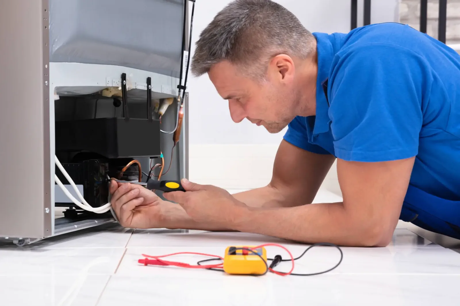 Appliance technician diagnosing an ice machine in a residential setting
